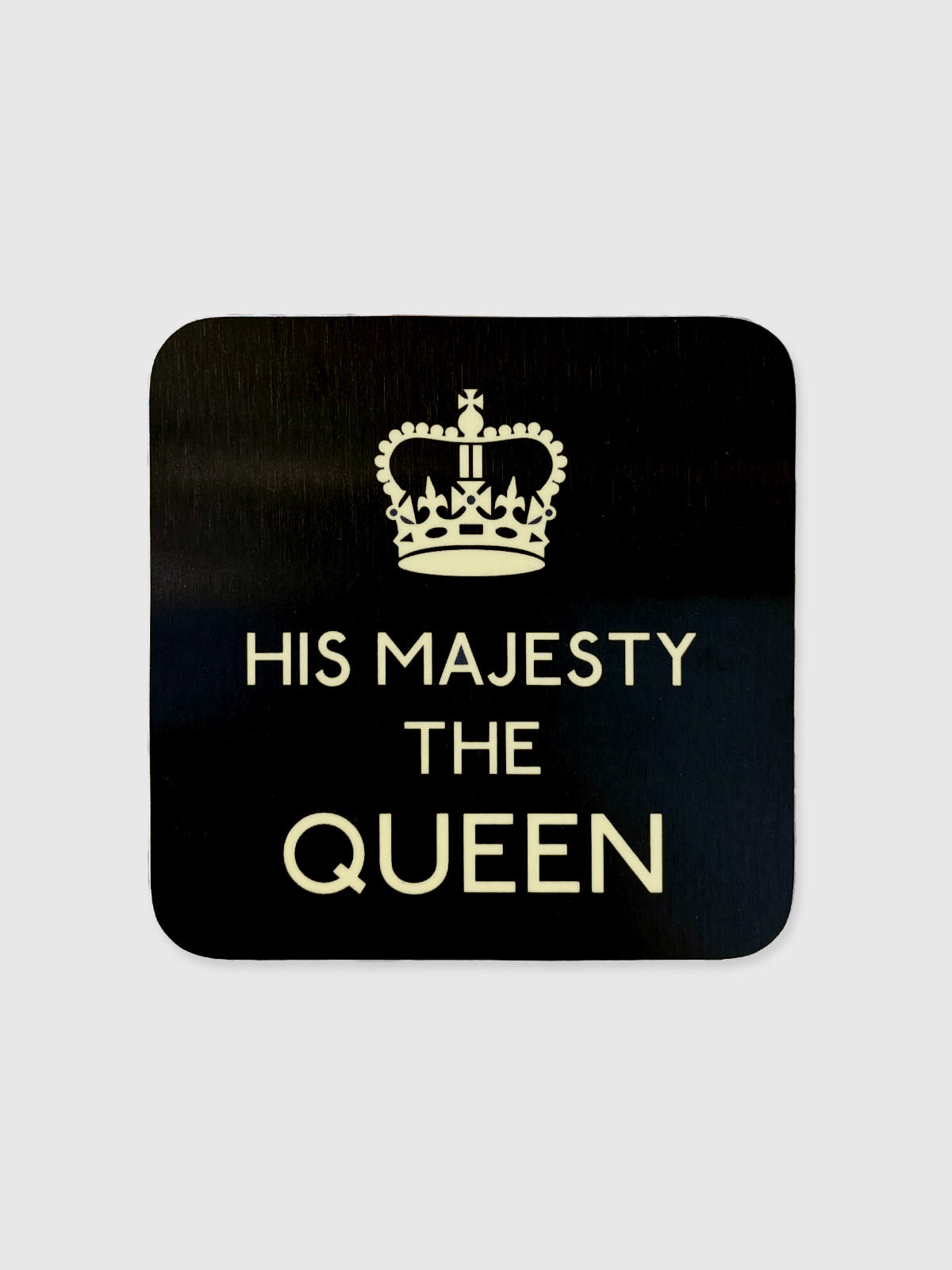 A black square glossy coaster with rounded edges featuring the text 'His Majesty The Queen' in white.